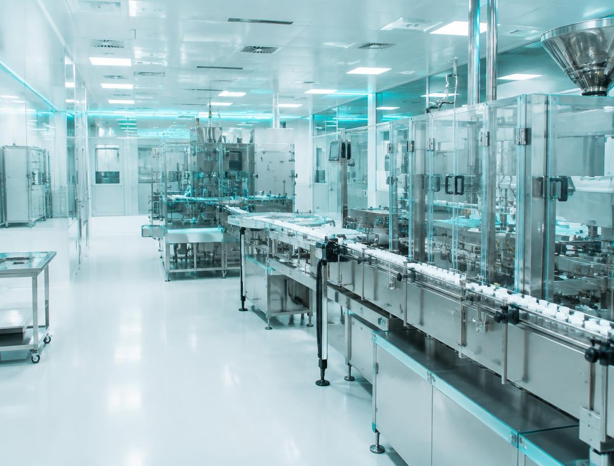 Pharmaceutical cleanroom production line in cool clinical lighting